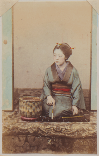 Shimooka Renjō, ‘Hikite-jaya onna (Woman from a tea house that arranges introductions to prostitutes)’/ ‘Proprietress of a tea house indulging in a pipe’, c.1863-70.