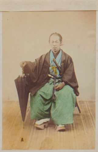 Shimooka Renjō, ‘Tsūji (Interpreter)’/ ‘Japanese Interpreter’, c.1863-70. A samurai official or yakunin poses with an imported umbrella. 